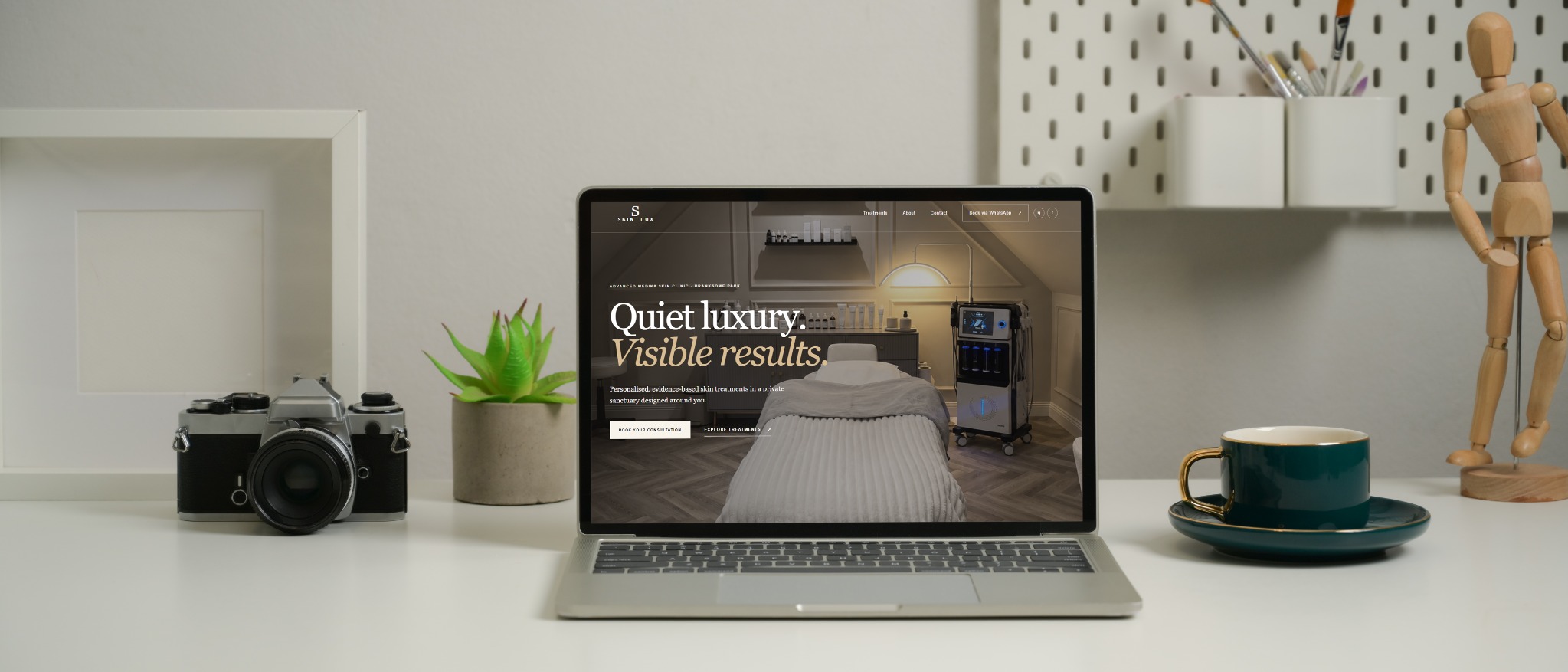 SkinLux website designed by CoastIQ shown on a laptop